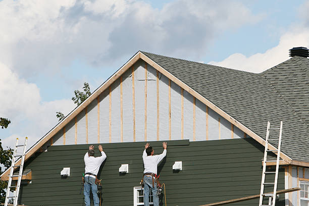 Professional Siding technician working in Utica, IN